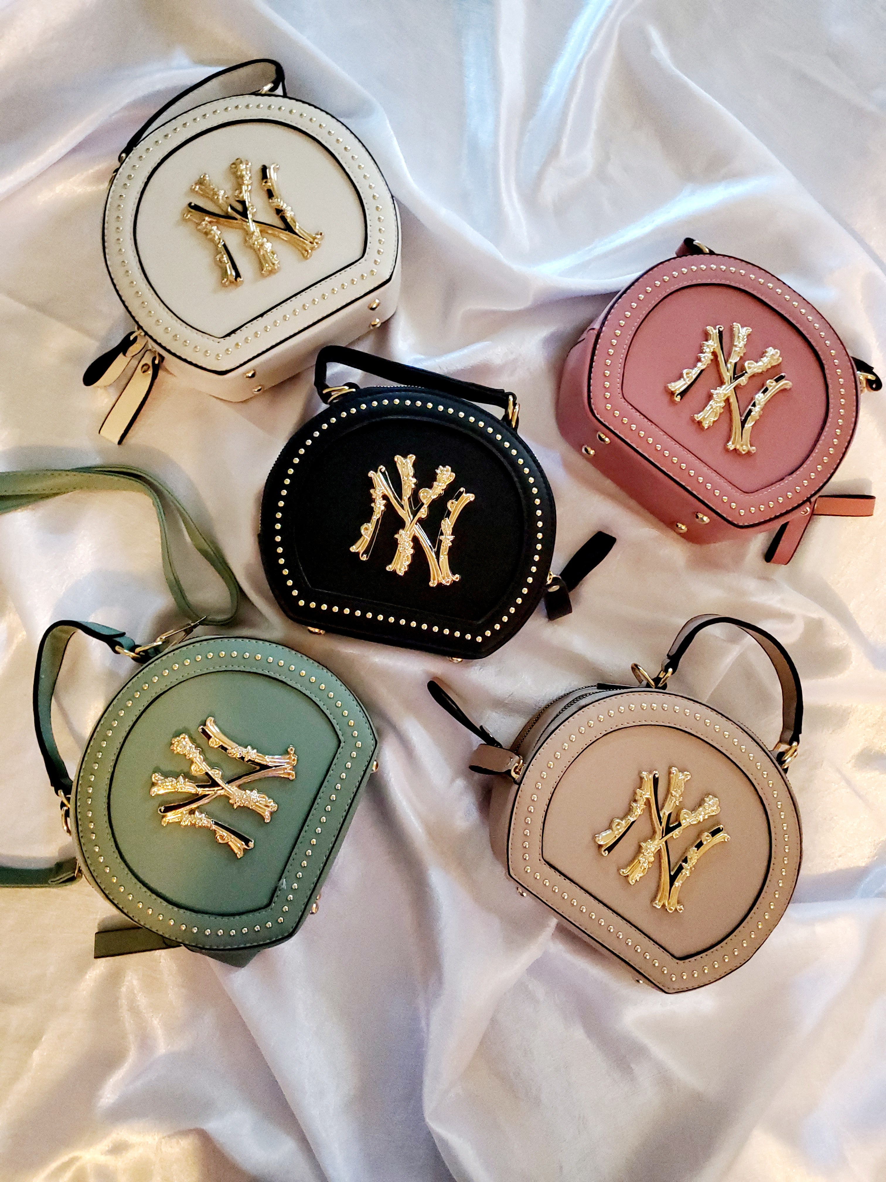 These NY handbags can be worn crossbody, shoulder, or handle PU Leather Don't forget to grab the NY Yankees hat to match!